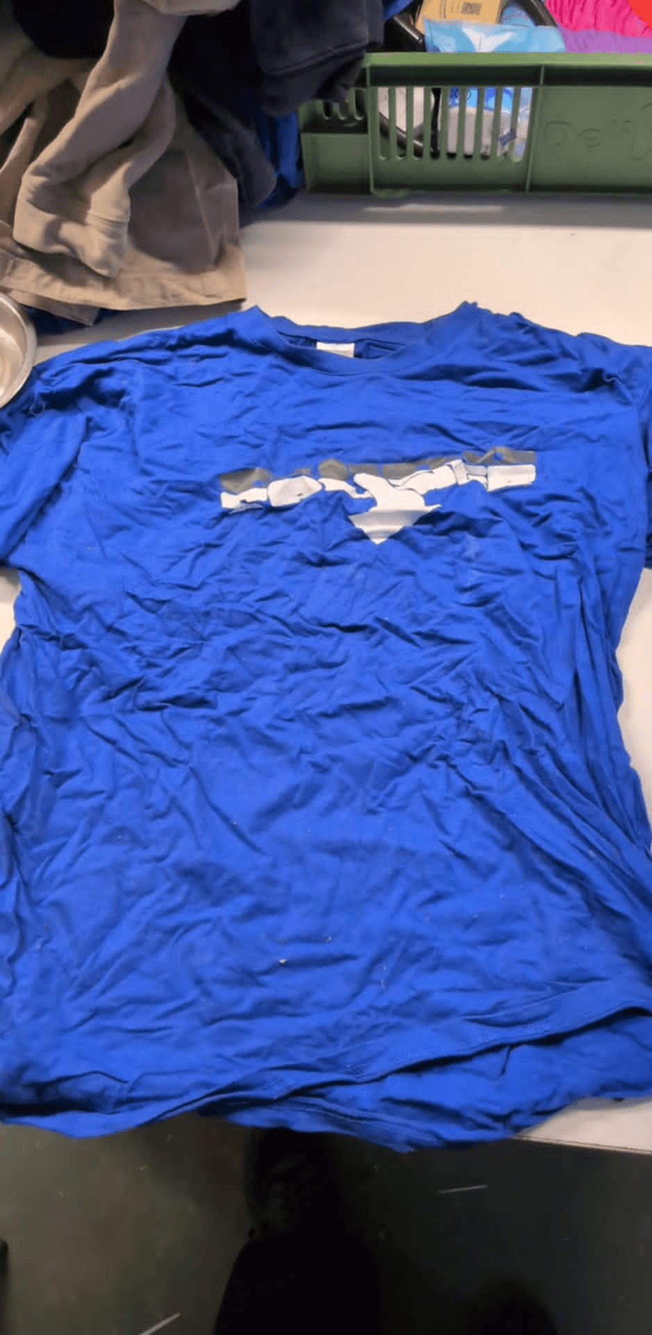 a blue t-shirt with a picture of a shark on it