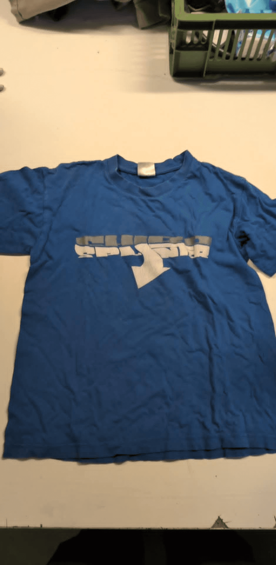 a blue t-shirt with a white logo on it